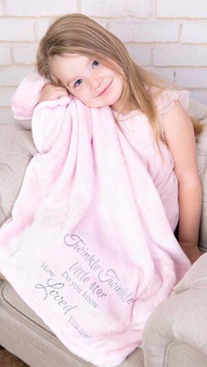 little girl with pink mink touch twinkle blanket